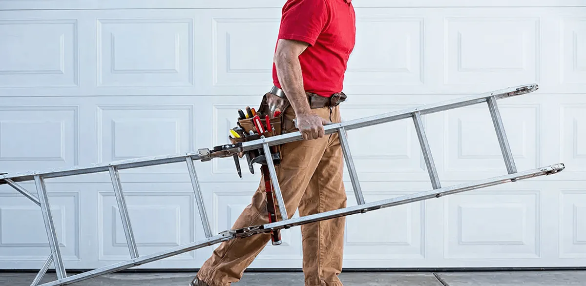 Garage door repair technician arriving with tools and ladder in Chattanooga, TN